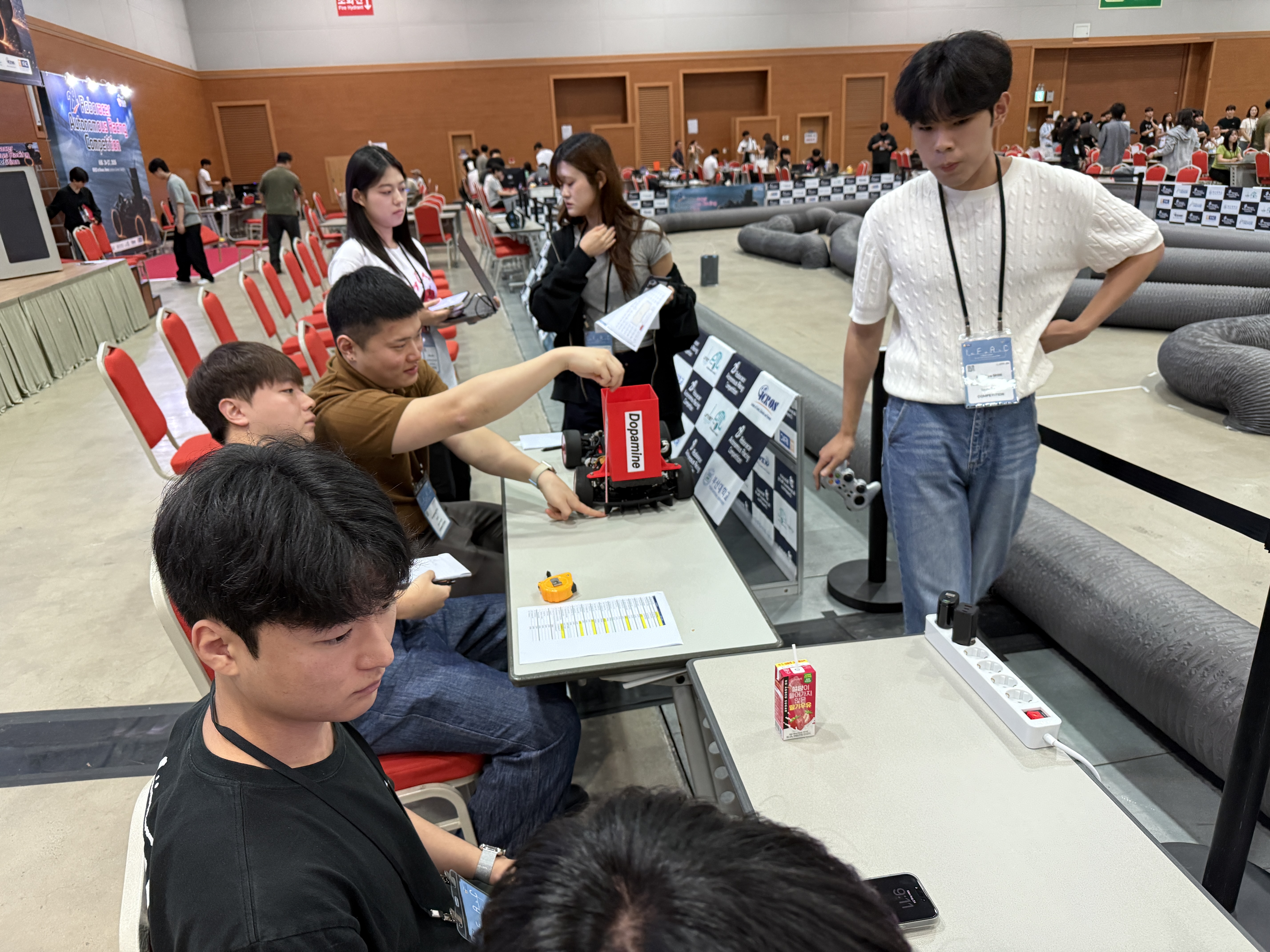 Team members working beside the race track
